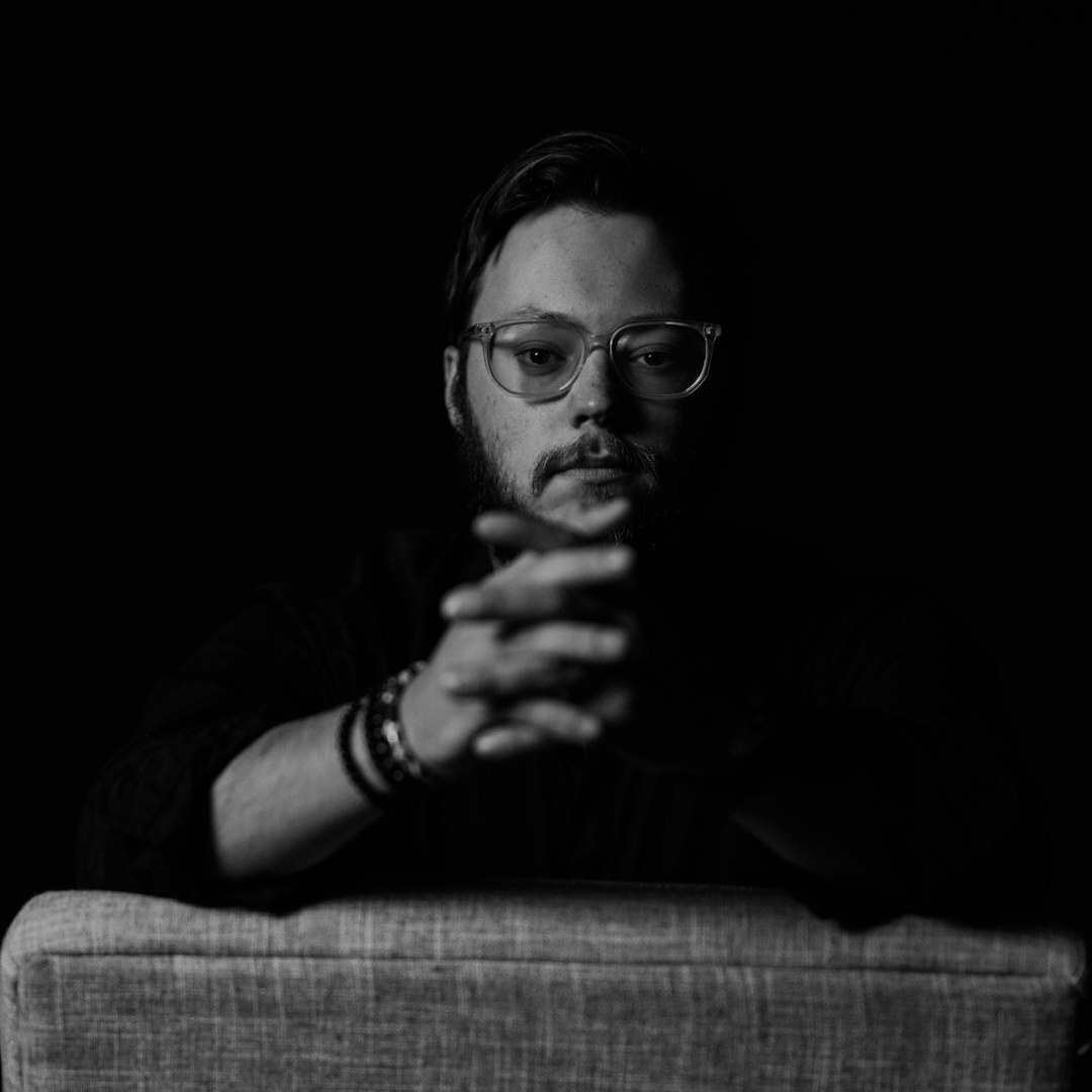 Male media analyst with glasses professional headshot