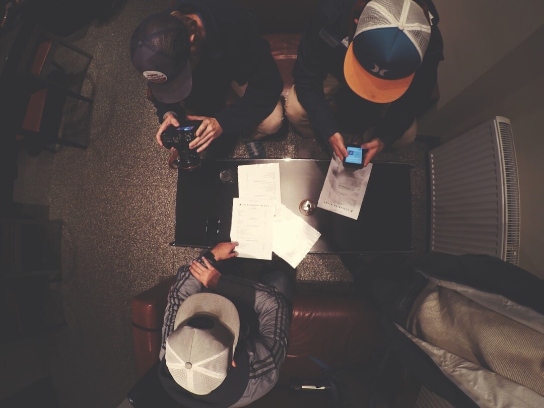 Journalists in editorial meeting with laptops and notepads